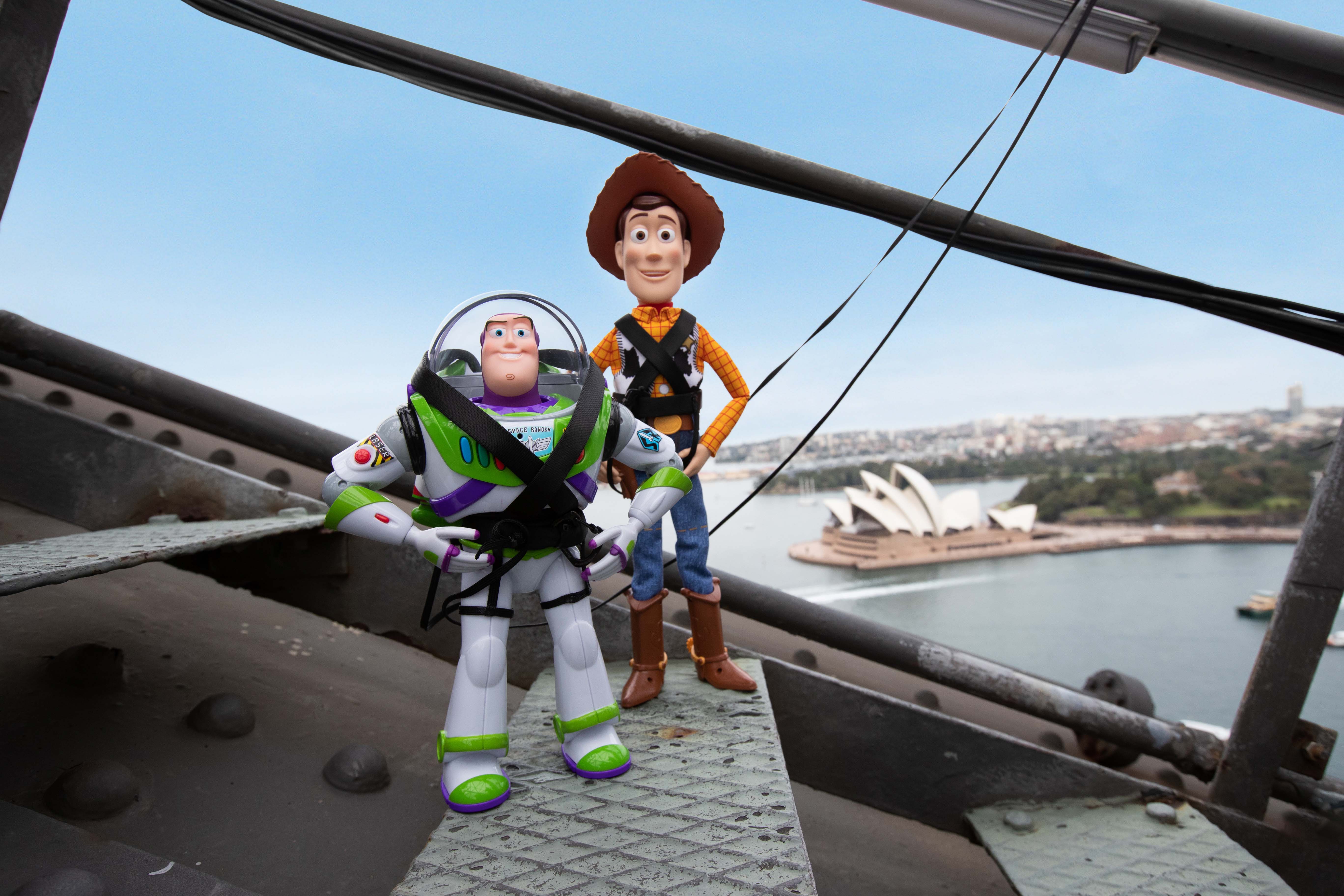 Buzzlight Year and Woody climbing the Sydney Harbour Bridge