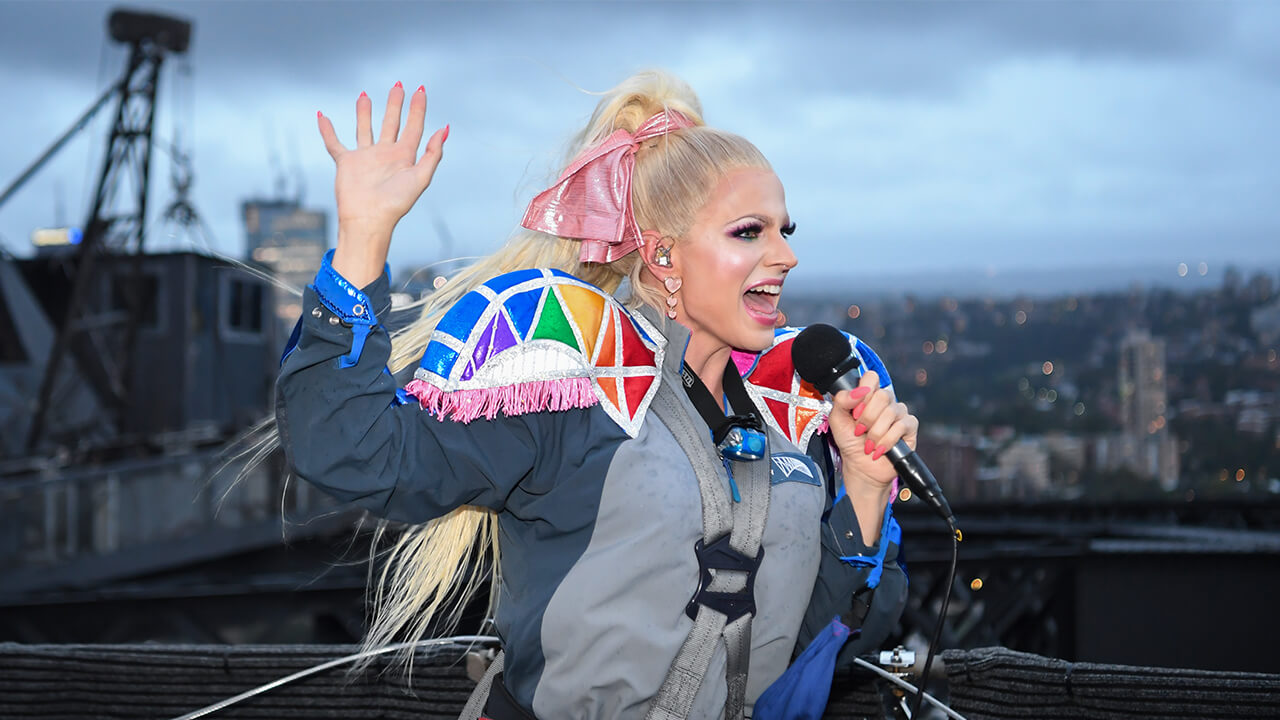 Drag queen Courtney Act performed on top of Australia’s iconic Sydney Harbour Bridge to kick off BridgeClimb’s Mardi Gras celebrations