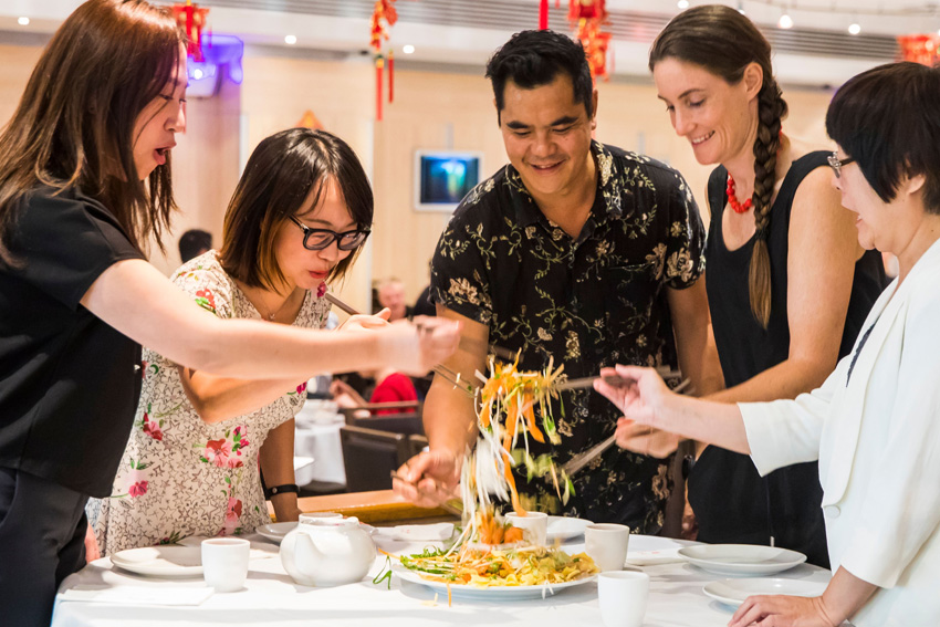 Friends enjoying a prosperity toss salad