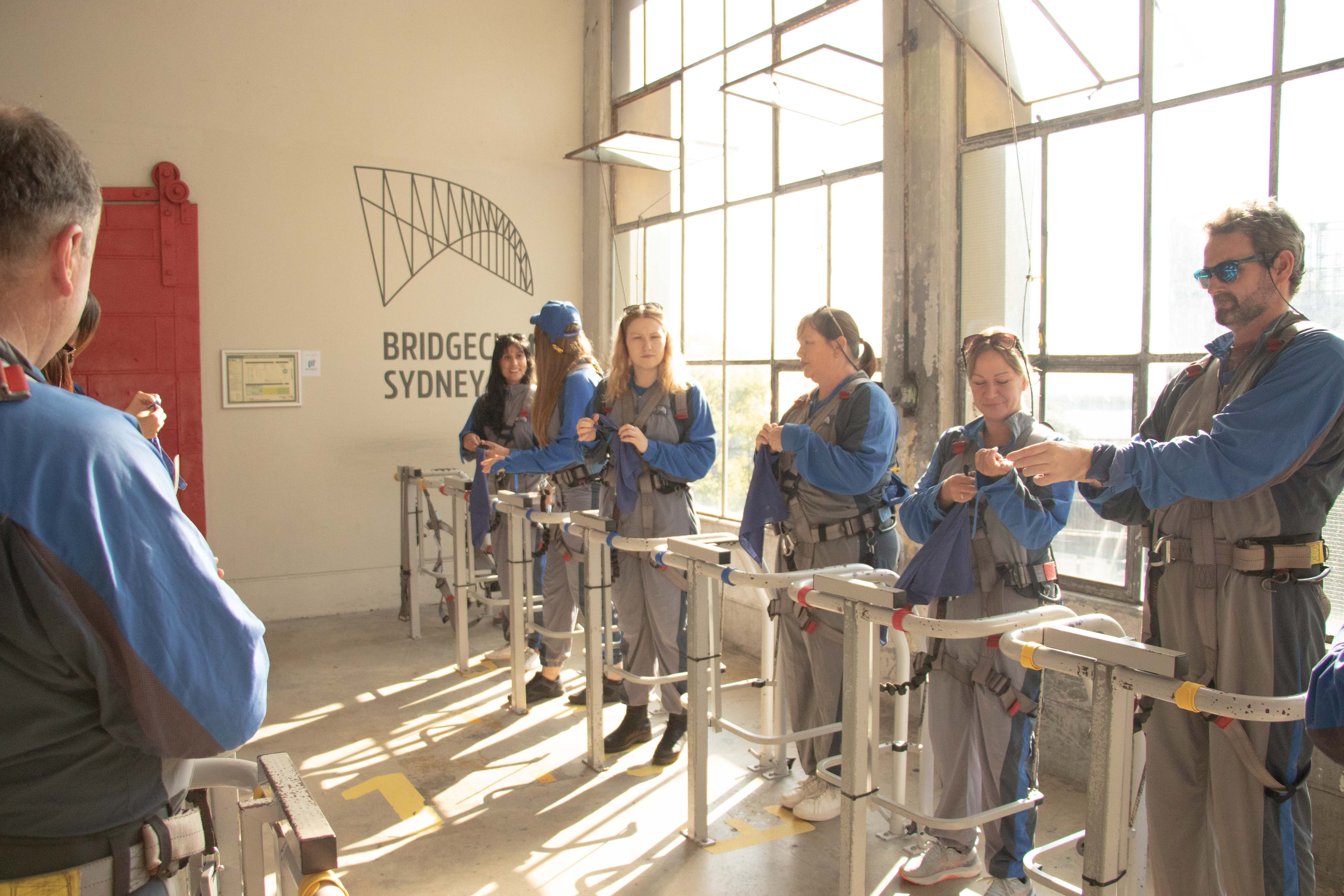 guests getting ready to climb standing at harness cradle