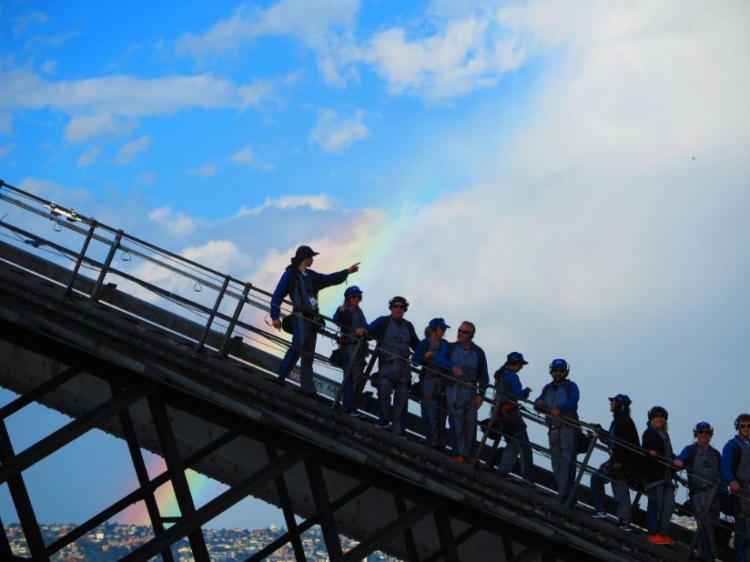 Climbers looking at a rainbow