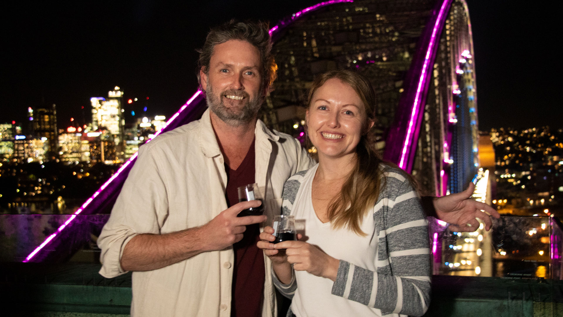 couple smiling at the pylon lookout during vivid sydney