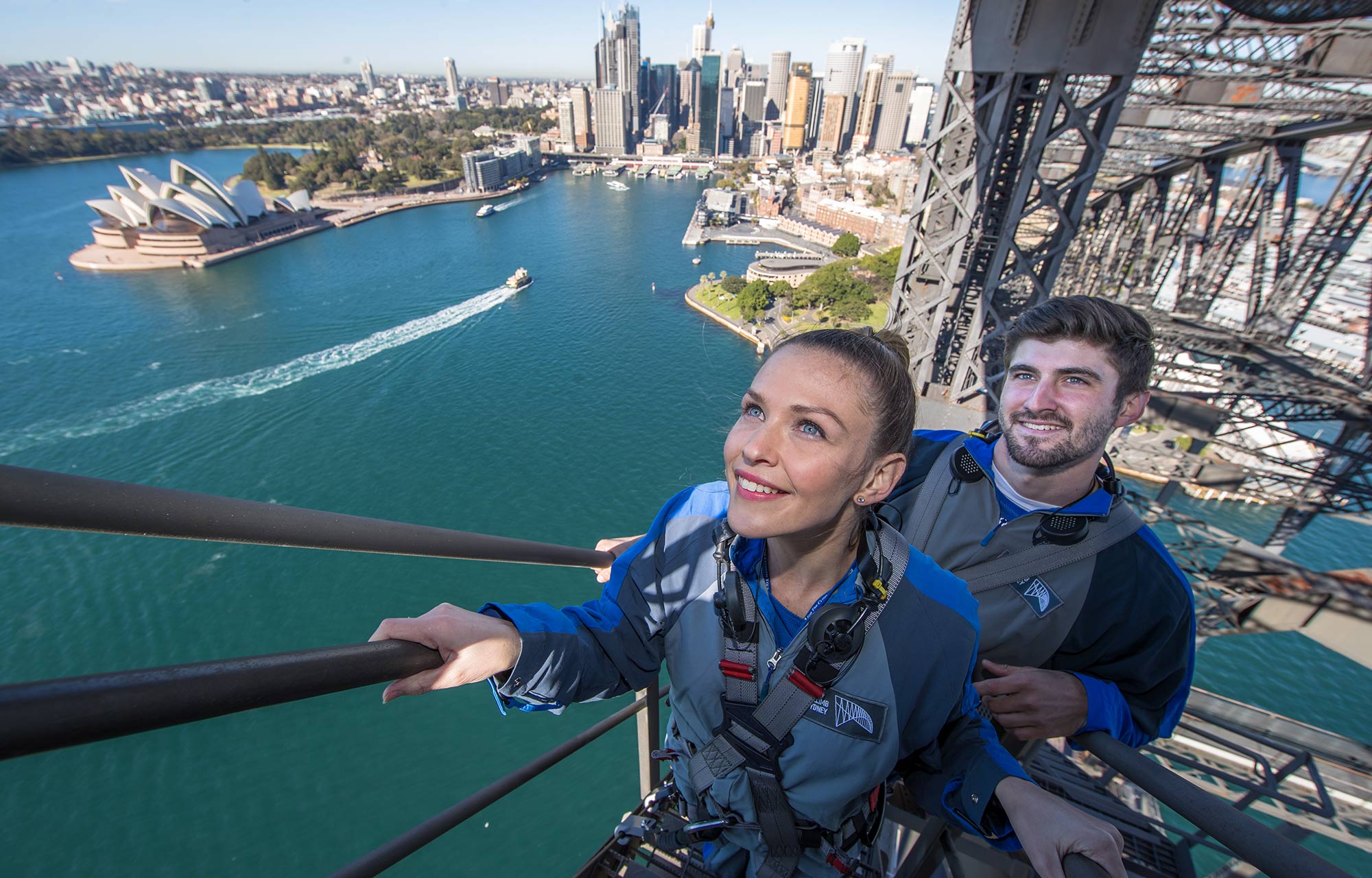 woman and man climbing the stairs of the sydney harbour bridge inner arch
